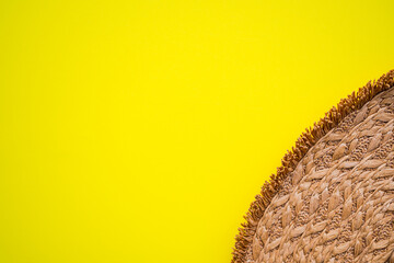 Close up hat on yellow paper background.  for sun protection tourist travel summer holidays. top view or flat lay with copy space.