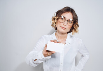 Business woman with a business card on a light background work advertisement