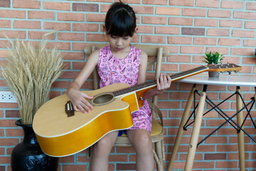 asian girl sitting on the guitar