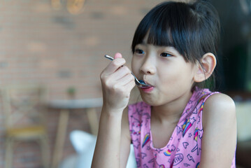 Asian child cute girl Eat Fruit Berry