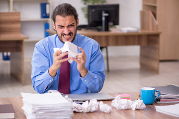 Young male employee in brainstorming concept