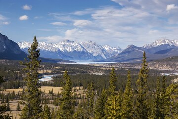 Scenic Aerial View of Kootenay Plains Ecological Reserve, Distant Abraham Lake and Rocky Mountain Peaks on Horizon. Sunny Early Springtime Day Landscape in Canadian Rockies