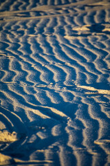 sand patterns in the largest gypsum white sand desert in the world, the White Sands National Park in New Mexico .