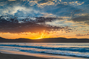 Sunrise seascape at the beach with haze and cloud