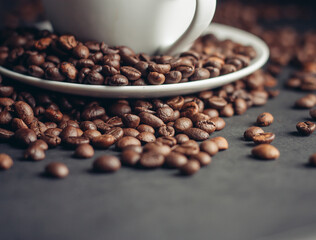 white cup with coffee beans on gray background Arabica variety