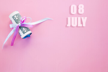 calendar date on pink background with rolled up dollar bills pinned by pink and blue ribbon with copy space. July 8 is the eighth day of the month