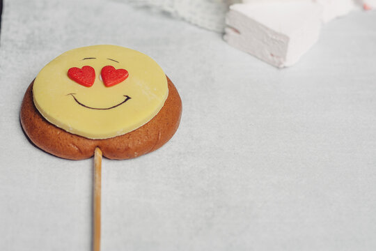 gingerbread in the form of a smiley on a stick sweets candy dessert delight snack
