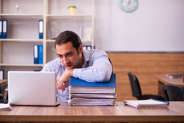 Young male employee working in the office