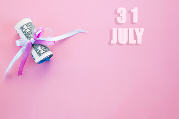 calendar date on pink background with rolled up dollar bills pinned by pink and blue ribbon with copy space. July 31 is the thirty-first day of the month