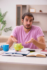 Young male student preparing for exams at home