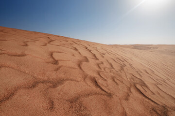 Sunset over the sand dunes in the desert.