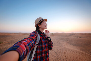attractive asian young woman in plaid shirt in desert