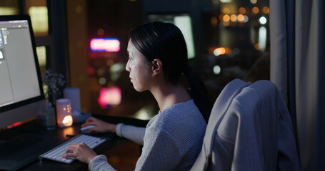 Woman read on computer and work at night