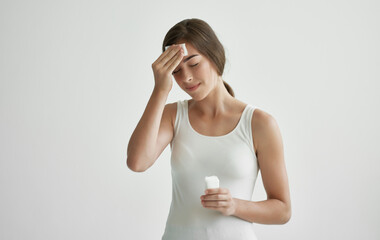 woman wiping her face with a handkerchief feeling unwell health cold