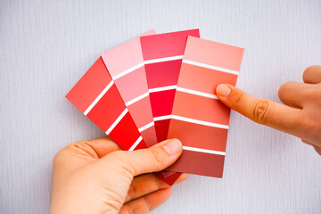 Woman choosing colour from color swatches