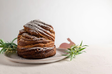Homemade Easter orthodox sweet bread  Kulich-Cruffin on a light background. Paska. Bright Easter holiday. Flaky dough of croissant meets moist muffin meets flavorful Kulich. Horizontal orientation.