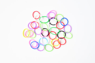 Background pile of colorful rubber bands and small on white background isolated .