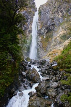 A vertical landscape photo of a waterfall 