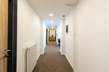 Interior of a long corridor in hotel apartment