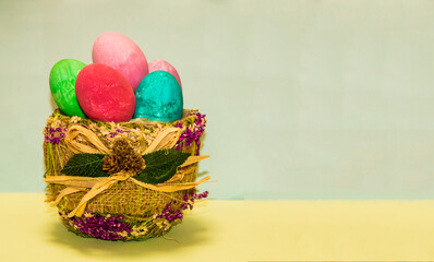Basket with easter eggs of different colors