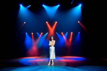 Artist posing on the scene in club. Bright stage lighting