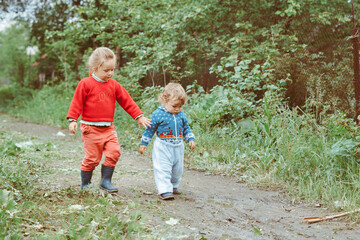 Fototapeta premium sister and brother walking down the street