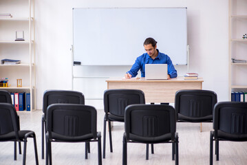 Young male business trainer making presentation during pandemic