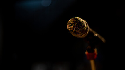 Side of Microphone on a stand with dark atmosphere as background