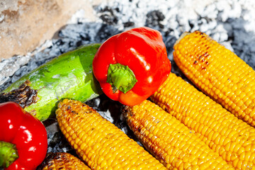 Picnic for vegans . Vegetables cooking on the campfire. Corn , peppers and zucchini