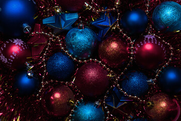 Fototapeta na wymiar Amazing Christmas composition with blue and red christmas balls. Christmas or New Year concept. Dark festive background with baubles. Top view.