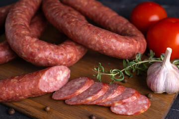 Sliced slices of homemade sausage. Homemade Krakow sausage on a cutting board