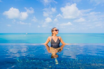 Portrait beautiful young asian woman relax smile leisure around outdoor swimming pool