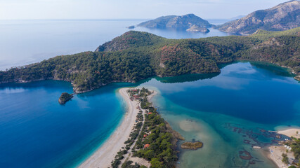 Panoramic and vivid shot of Oludeniz, also known as Blue Lagoon, in Fethiye. It is located on south-west of Turkey and it has been a tourist attraction with its blue sea, weather and coast.