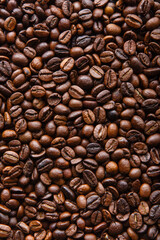 Roasted coffee beans background. Top view, vertical