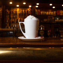 creamy frappe latte on bar desk in dark tones