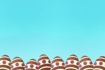 Easter eggs on light blue background. Colorful. Paper texture. Illustration.