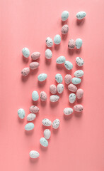 Vertical backdrop with small freckled quail eggs on pink