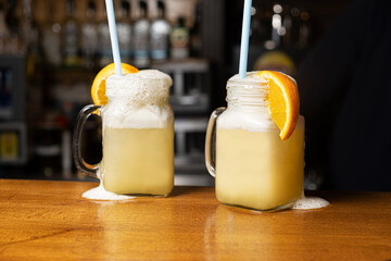 orange cocktail in jar mug