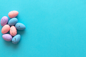 Minimal Easter concept. Multi-colored eggs on a blue and pink background. View from above. Flat lay, copy space