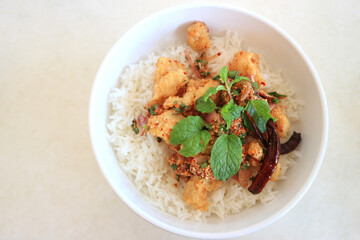 Rice and fried chicken in a white bowl, Top View.