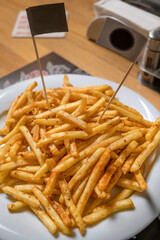spicy french fries on white plate