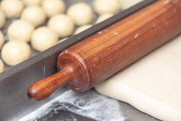 Dough's rolls with rolling pin on the table