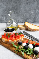 Italian bruschetta with tomatoes, olive oil, green parsley and pink pepper. typical Italian antipasti starter in a restaurant in Italy Rome Milan. tomato bruschetta recipe, selective focus