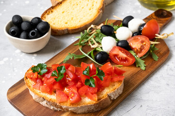 Italian bruschetta with tomatoes, olive oil, green parsley and pink pepper. typical Italian antipasti starter in a restaurant in Italy Rome Milan. tomato bruschetta recipe, selective focus