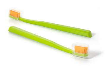 Two green toothbrushes on a white background. Full depth of field. With clipping path.