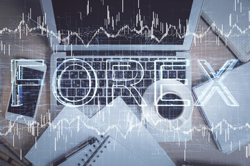 Stock market chart and top view computer on the table background. Double exposure. Concept of financial analysis.