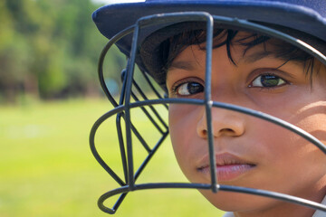 Portrait of boy wearing cricket helmet