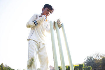 a boy wicket keeper during cricket game