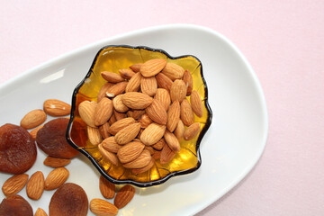 Almonds and dry apricots in the bowl, top view