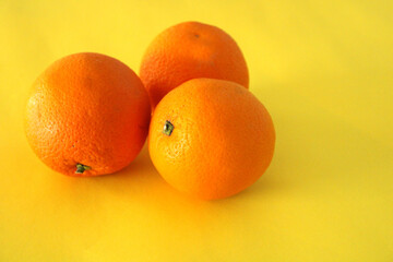  Oranges on a yellow background, fresh fruits